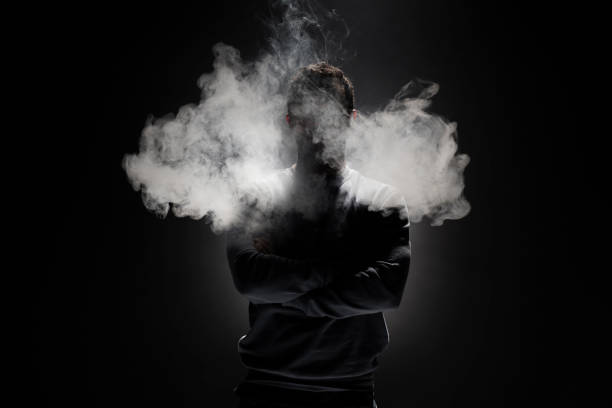 istock Man and Smoke fragments on a black background 679754800