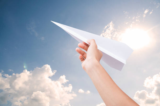 istock Hand holding paper plane toward cloudy blue sky concept new innovation and new creativity. 679764562