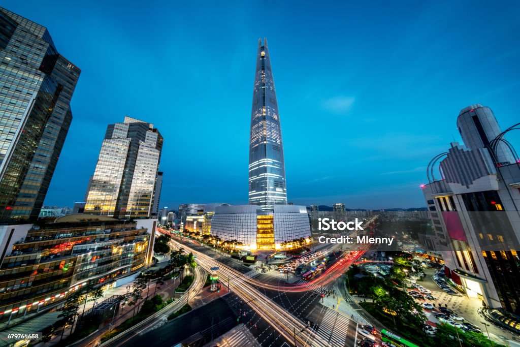Seoul Songpagu Cityscape Skyscraper Lotte World Tower at Night Cityscape of Songpagu district in Seoul at night. Motion blurred traffic lights, illuminated skyscrapers and Lotte world tower. Seoul, South Korea, Asia. Aerial view wide angle 42 MP Sony A7RII. Korea Stock Photo