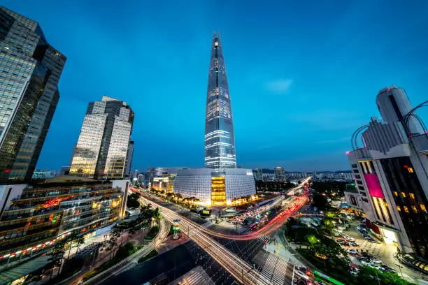 Cityscape of Songpagu district in Seoul at night. Motion blurred traffic lights, illuminated skyscrapers and Lotte world tower. Seoul, South Korea, Asia. Aerial view wide angle 42 MP Sony A7RII.