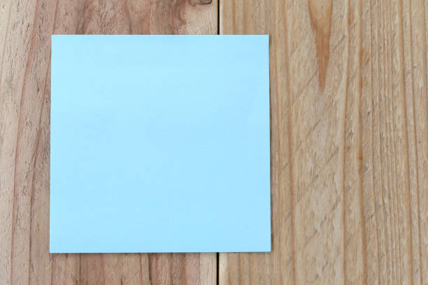 istock Blue paper note on old brown wood background for design and input text. 679764660