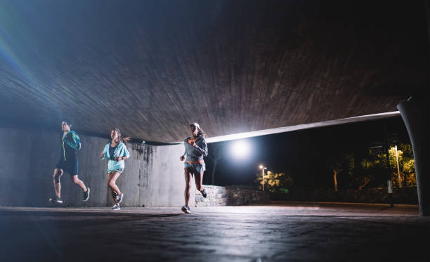 istock Group of runners training in the city at night 679769742