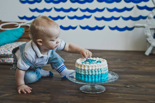 istock The child is tasting the cake with his hands 5562. 679777074