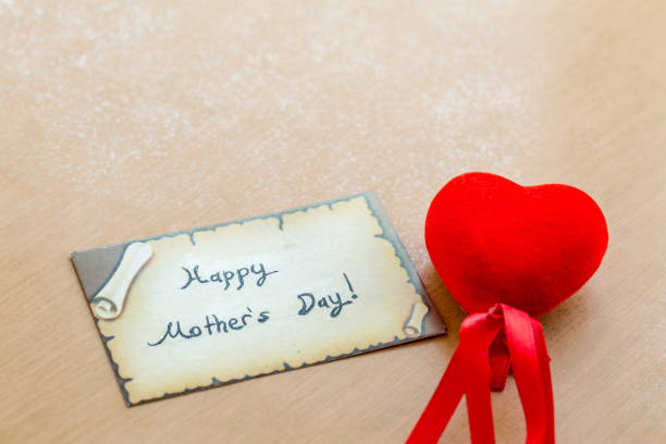 istock Happy mother's day with red  heart on a brown table 679781902