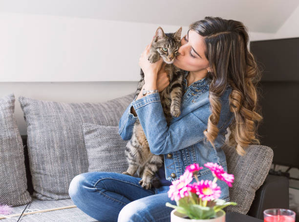 istock Young woman kissing her cat 679782208