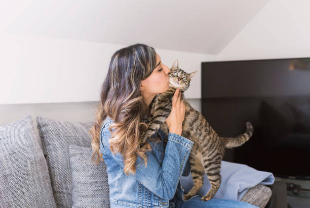 istock Happy woman kissing her cat 679782376