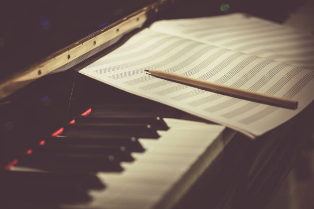 Old wooden table with sheet music. 