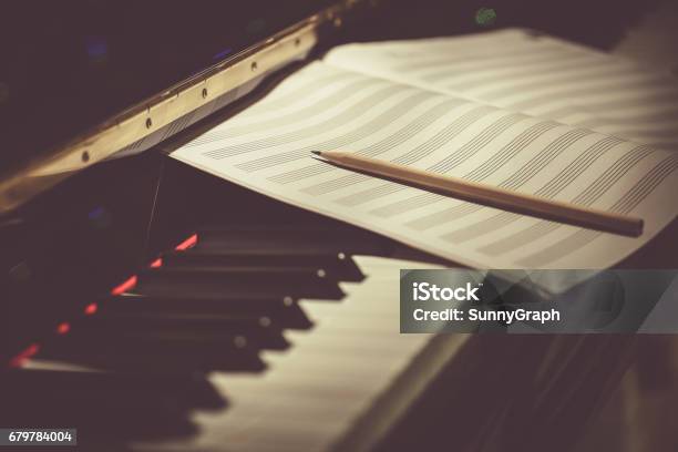 Compose Concept Pencil And Sheet Music On The Piano Keyboard Stock Photo - Download Image Now