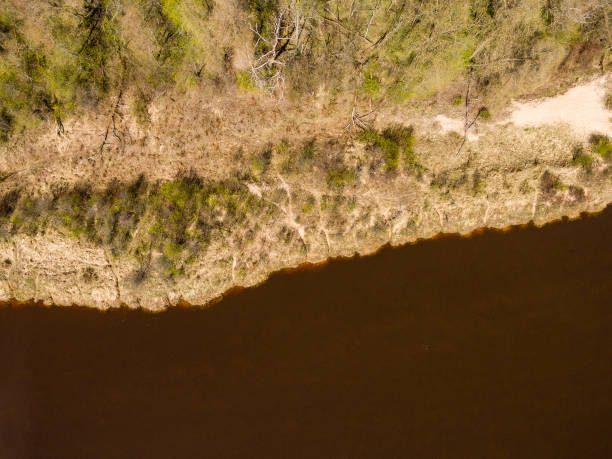 istock drone image. aerial view of rural area with river Gauja 679793280