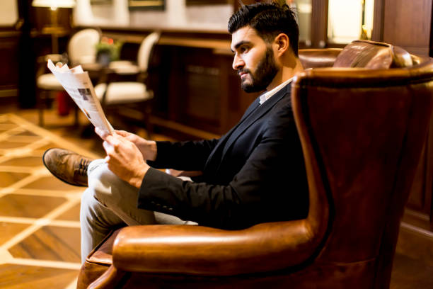 istock Modern businessman reading newspaper 679797894