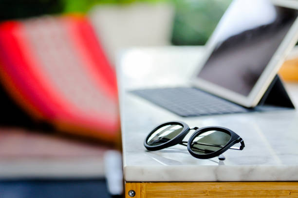 istock sunglass and notepad on the table, selective focus on the sunglass on holiday 679798266