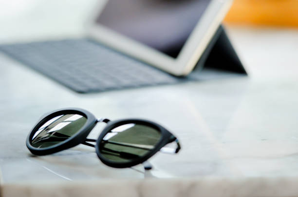 istock sunglass and notepad on the table, selective focus on the sunglass on holiday 679798406