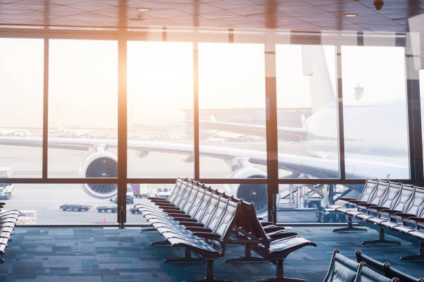 istock Airport boarding gate with seats, windows and aircraft 679798996