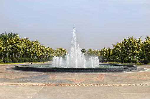The big water fountain in the public green park at thailand.