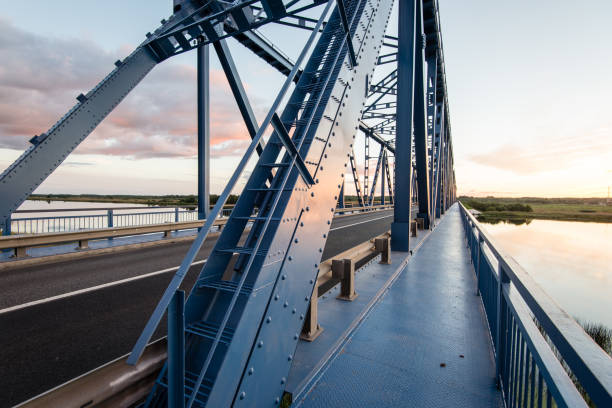 istock railway bridge with metal rails near river 679800336