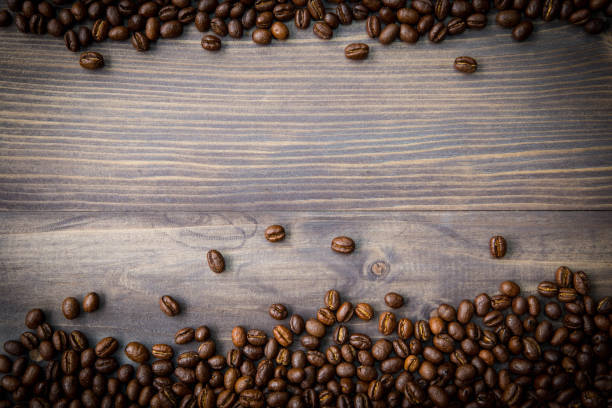 istock Peaberry coffee beans on wooden background 679817944