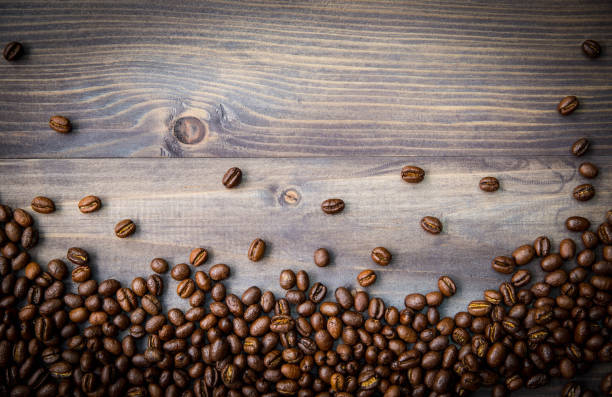 istock Peaberry coffee beans on wooden background 679818640