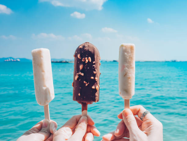 istock Ice cream on  hand with the sea background. 679819460