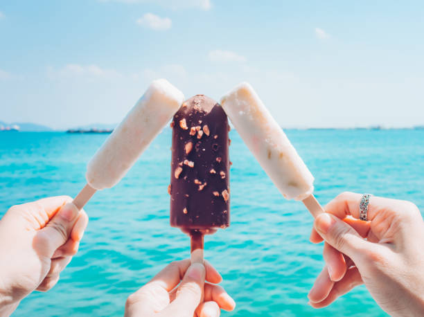 istock Ice cream on  hand with the sea background. 679819464