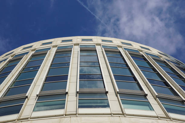 istock Perspective and underside angle view to textured background of contemporary glass building skyscrapers . 679819564