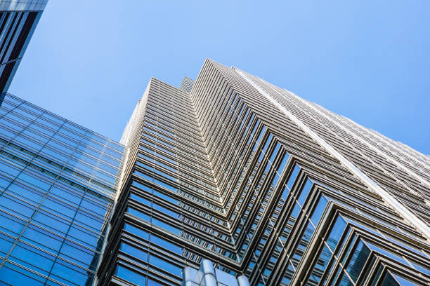 istock Perspective and underside angle view to textured background of contemporary glass building skyscrapers . 679819648