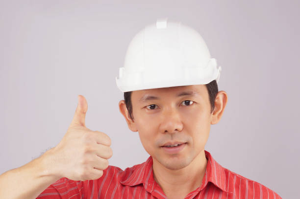 istock Engineer wear red shirt and white hat make signal thumb 679821046