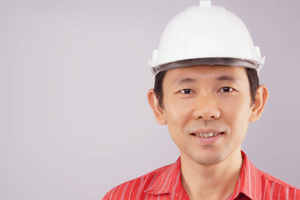 istock Happy engineer wear red shirt and hat look to front 679821476