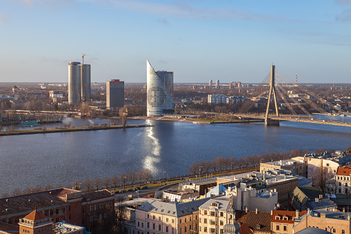 RIGA, LATVIA - 25 DEC 2015. Modern bank building and cable-stayed bridge over Daugava river