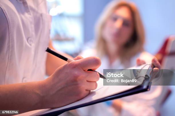 Close Up Of Doctor Writing On A Medical Chart Stock Photo - Download Image Now - Medical Research, Patient, Clipboard
