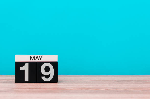 istock May 19th. Day 19 of month, calendar on turquoise background. Spring time, empty space for text 679839268