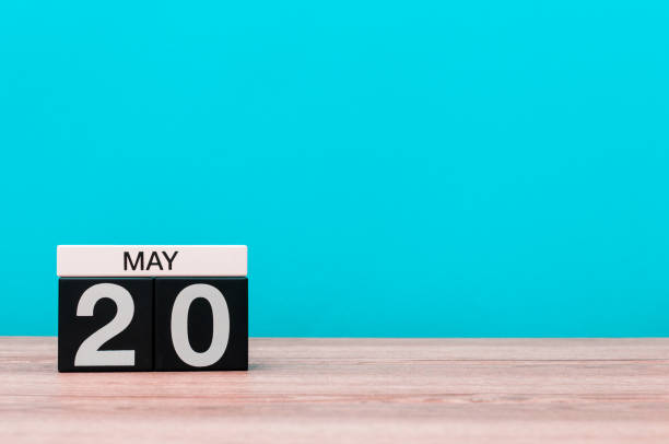 istock May 20th. Day 20 of month, calendar on turquoise background. Spring time, empty space for text 679839406