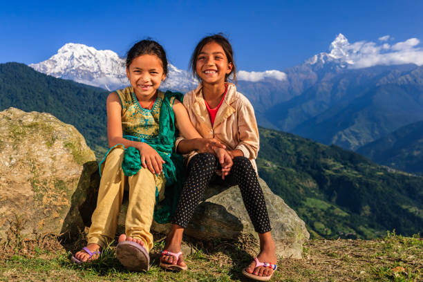Happy Nepali little girls, Annapurna Range on background Happy Nepali little girls, Annapurna Range on background. The Annapurna region is in western Nepal where some of the most popular treks (Annapurna Sanctuary Trek, Annapurna Circuit) are located. Peaks in the Annapurnas include 8,091m Annapurna I, Nilgiri and Machhapuchchhre. The Annapurna peaks are among the world's most dangerous mountains to climb. annapurna circuit photos stock pictures, royalty-free photos & images