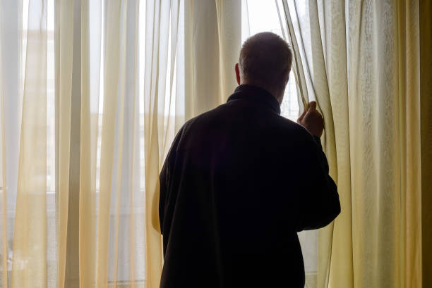 istock Man Looking out of the Window 679852856
