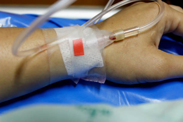 istock saline solution in a patients hand at hospital 679853386