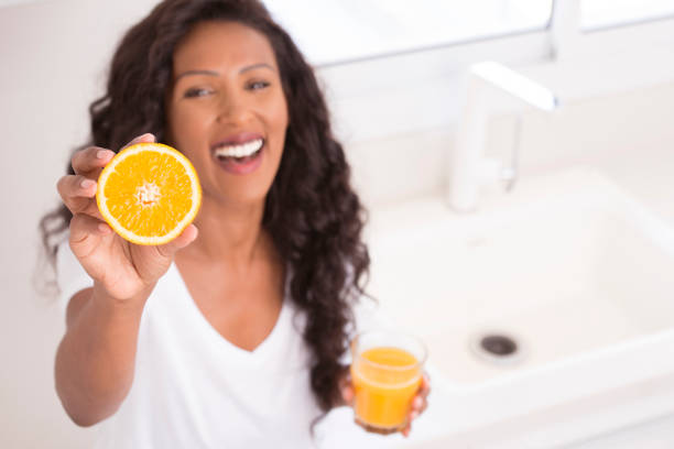 Woman drinking fresh orange juice.
