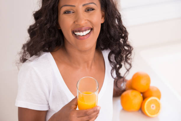 istock Woman drinking fresh orange juice. 679859920