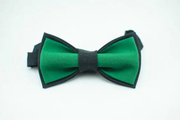 Stylish and well-designed green-black bow tie on a white background; isolated