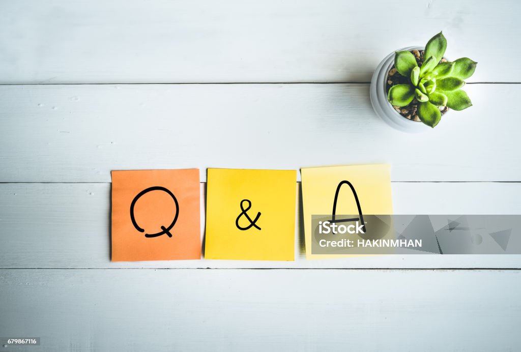 Q & A word with paper note on wood table Q & A word with paper note on white wood table backgrounds Q and A Stock Photo