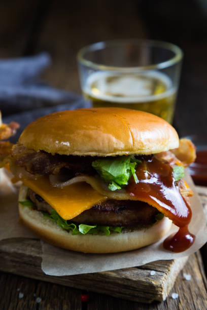istock Hamburgers and beer on a wooden table 679867426