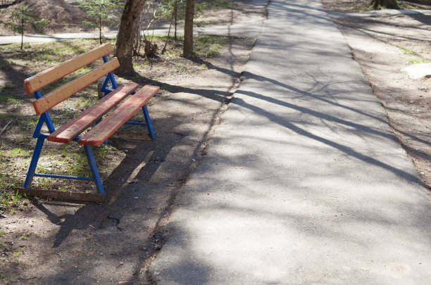 istock The old bench next to an asphalt track. 679868002