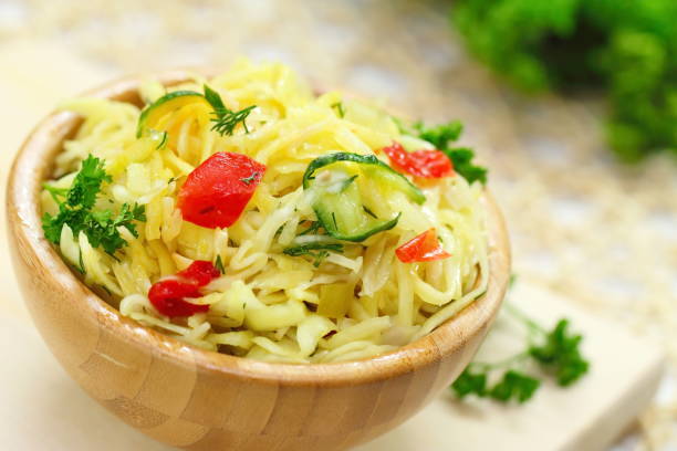 salad with pickled cabbage, cucumbers, paprika and olive oil - sauerkraut cabbage paprika salad imagens e fotografias de stock