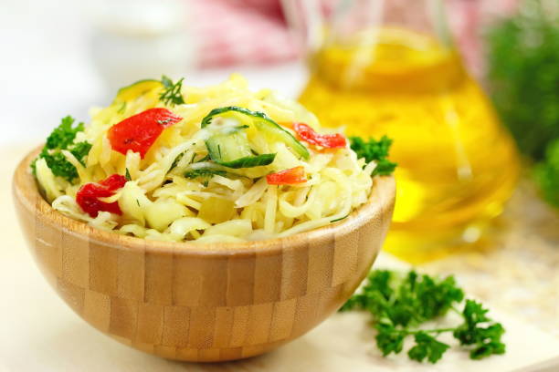 salad with pickled cabbage, cucumbers, paprika and olive oil - sauerkraut cabbage paprika salad imagens e fotografias de stock