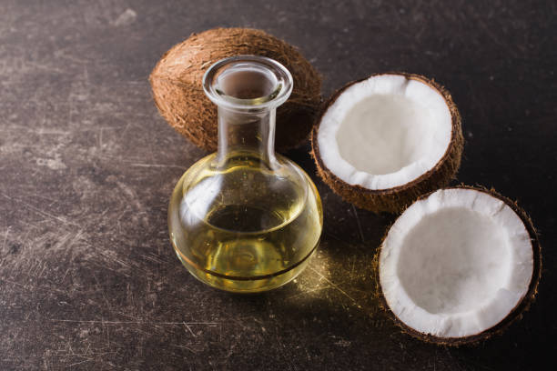 istock Coconut and coconut milk on a dark marble background. Exotic large walnut. Personal care. Spa treatments 679868970