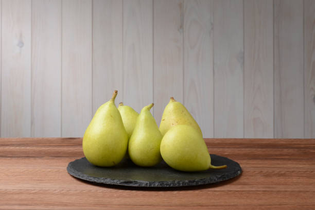 istock Pears on a plate of round black slate 679888898