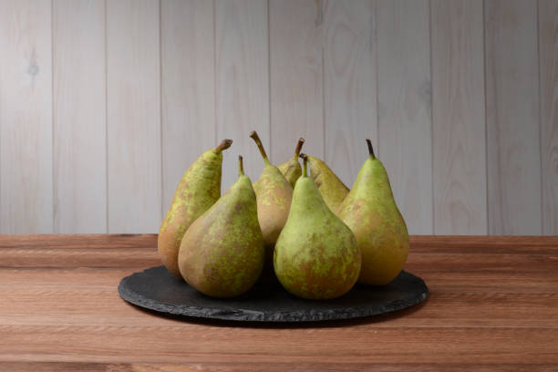 istock Pears on a plate of round black slate 679888924