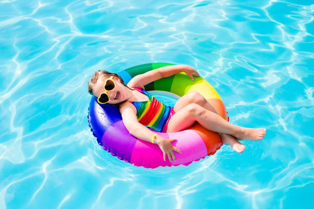 istock Child with toy ring in swimming pool 679894170