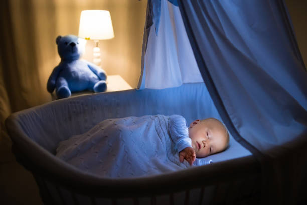 istock Baby boy drinking milk in bed 679894312