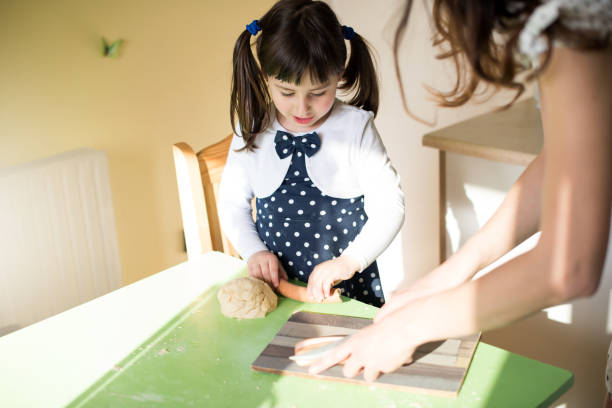 istock Little girl baking at the kitchen 679894472