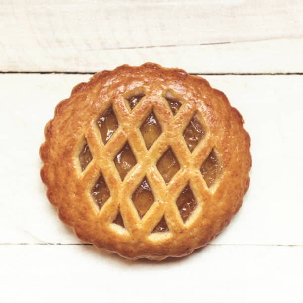 istock Apricot jam cookies on white table 679895402