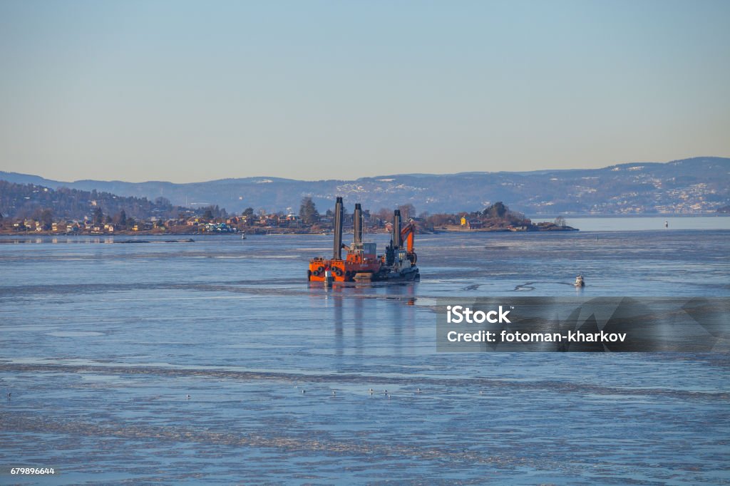 OSLO, NORWAY - 27 FEB 2015. Dredge ship in harbor bay. Barge Stock Photo